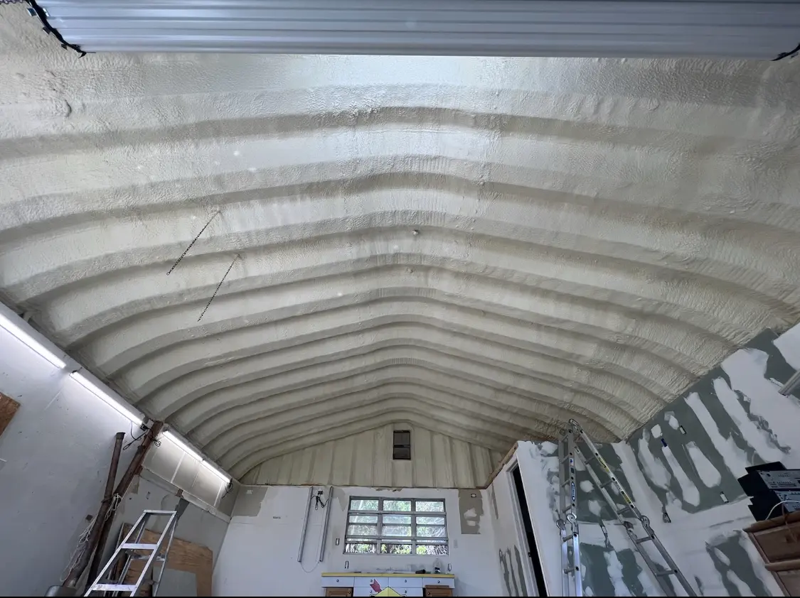 Spray polyurethane foam applied to the underside of a metal roof deck in Rothschild